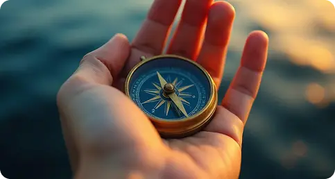 a hand holding a compass