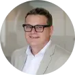 a man wearing glasses and a suit