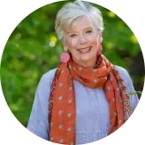 a woman smiling with a scarf